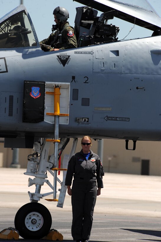 Maj. Paul Brown, Air Combat Command A-10 West Coast Demonstration Team pilot, completes final minute checks before he climbs out of his aircraft while Senior Airman Maura Gillis, Air Combat Command A-10 West Coast Demonstration Team crew chief, stands at attention here, May 29. The A-10 west demo team includes a select group of professionals who are dedicated to showing the capabilities of the A-10 aircraft through aerial maneuvers. (U.S. Air Force photo/Airmen 1st Class Adam Grant)
