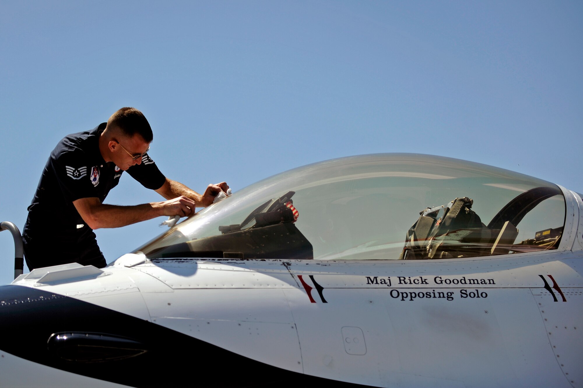 Staff Sgt. Jeremy Jackson, U.S. Air Force Thunderbirds dedicated crew chief on Thunderbirds No. 7 aircraft, cleans the canopy of the F-16 Fighting Falcon here, May 29, for the upcoming Dakota Thunder 2009 open house and air show here.  The Thunderbirds reinforce public confidence in the Air Force and demonstrate the professional competence of Air Force members to the public. (U.S. Air Force photo/Airman 1st Class Matthew Flynn)