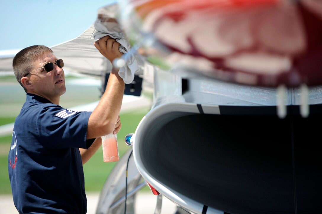Staff Sgt. Jory Cyr, U.S. Air Force Thunderbirds dedicated crew chief on Thunderbirds No. 3 aircraft, waxes the aircraft here, May 29.  Sergeant Cyr is preparing the F-16 Fighting Falcon for the upcoming Dakota Thunder 2009 open house and air show.  (U.S. Air Force photo/Airman 1st Class Matthew Flynn)