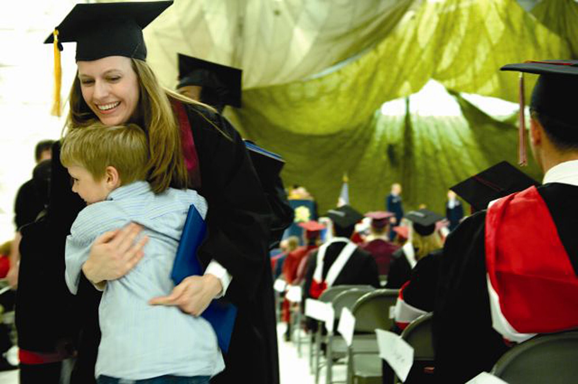 Tech. Sgt. Stephanie Atwell, 446th Maintenance Squadron, receives a hug from her son Danny at her 2007 graduation ceremony at McChord Air Force Base, Wash. Reservists like Sergeant Atwell have several educational benefits to chose from - some old, some new. (Air Force file photo/Abner Guzman)