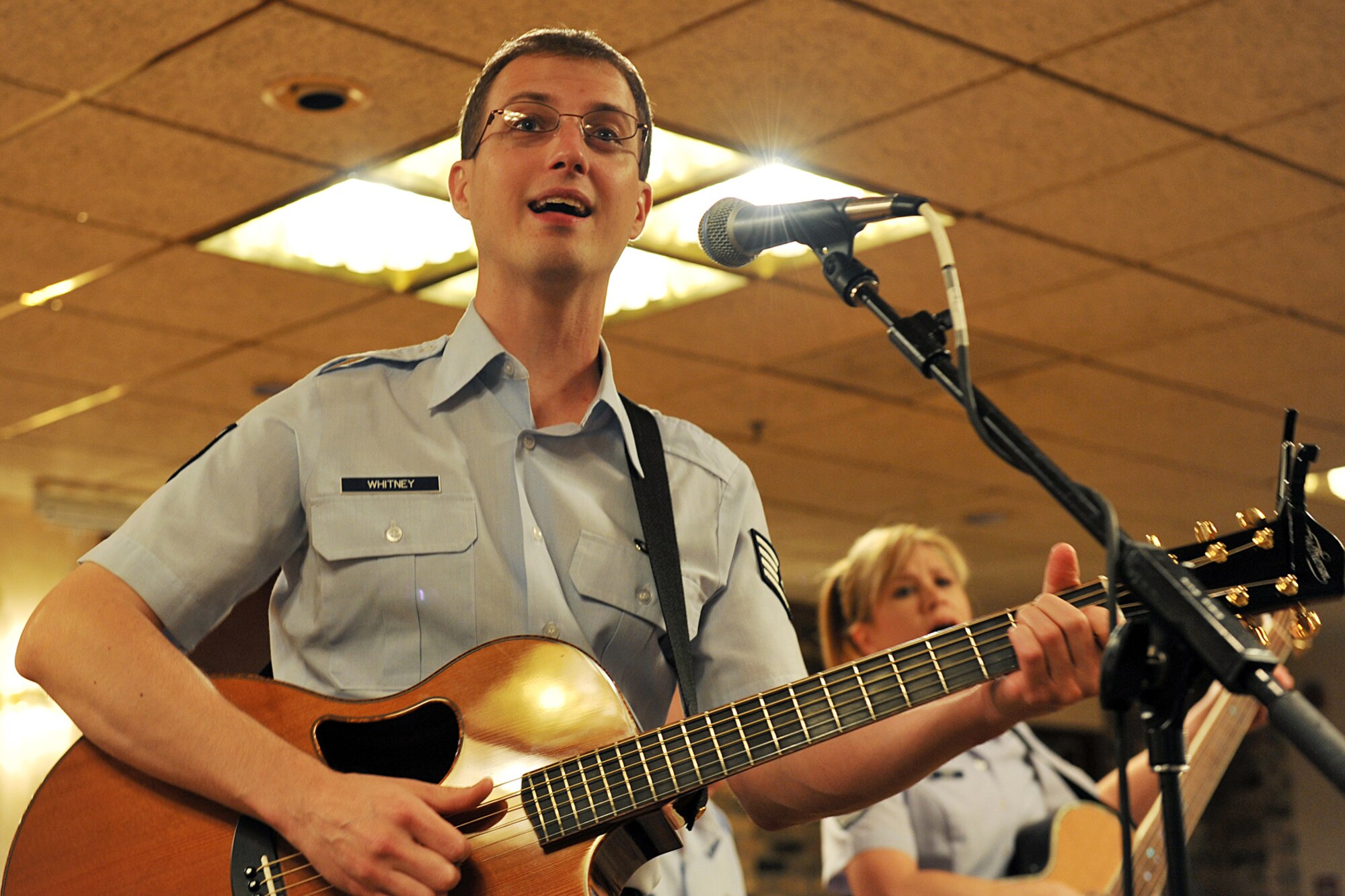 OFFUTT AIR FORCE BASE, Neb., -- Staff Sgt. Clint Whitney, a vocalist and guitarist with the Heartland of America Band, sings to members of Team Offutt during the first concert of the Lunch Bachs concert series at the Community Center here May 28. The concert series consits of four free 45-minute concerts. U.S. Air Force photo by Charles Haymond
