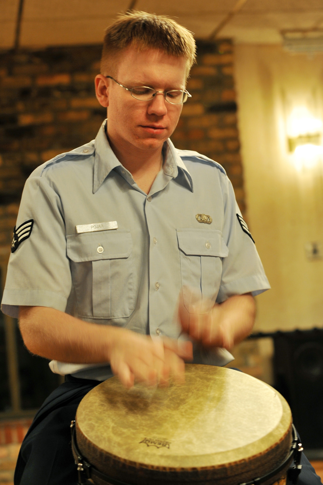 OFFUTT AIR FORCE BASE, Neb., -- Senior Airman David Pojar,a  percussionist with the Heartland of America Band, plays a drum during the first concert of the Lunch Bachs concert series at the Community Activity Center here May 28. The concert series consists of four 45-minute concerts. U.S. Air Force photo by Charles Haymond 