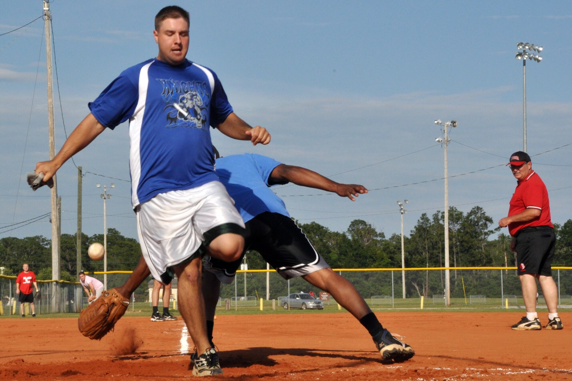 EGLIN AIR FORCE BASE, Fla. – Senior Airman Sandor Bocsi, a player for the 96th Security Forces Squadron Knights, squeaks past a 96th Medical Group catcher to score during an American League intramural softball game, May 27. The Knights held off the 96th Med Group, 11-9. (U.S. Air Force photo/ Airman Anthony Jennings)