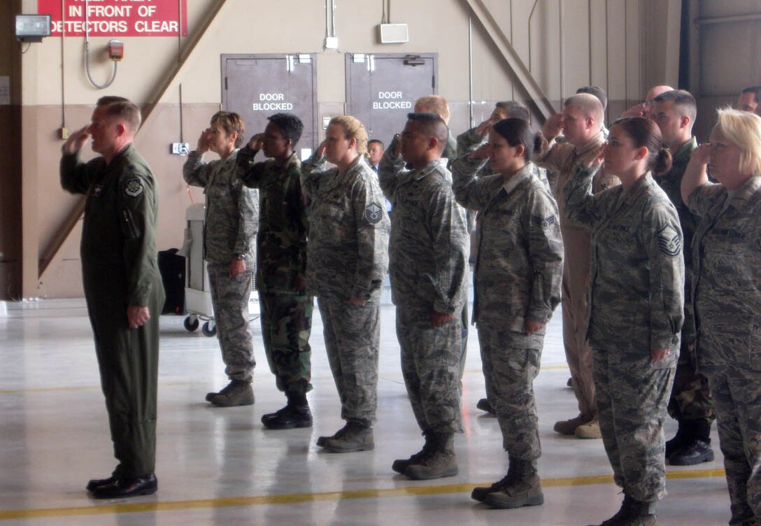 Members of the 926th Group render their first salute to Col. Herman Brunke, the new commander, during a change of command ceremony May 29. The 926th GP is an associate unit to the United States Air Force Warfare Center, whose personnel are fully integrated into regular Air Force operations at Nellis. The change of command was the unit's first since its establishment at the base in 2005. (Photo by Capt. Jessica Martin)