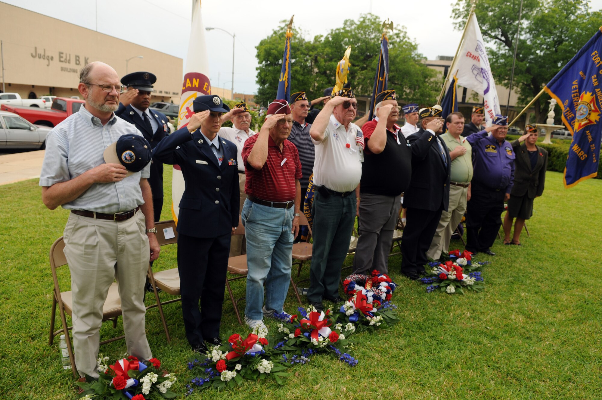Veterans and guests salute the flag at the Veterans' Memorial at the Tom Grean County Courthouse May 25. (U.S. Air Force photo by Tech. Sgt. John Barton)