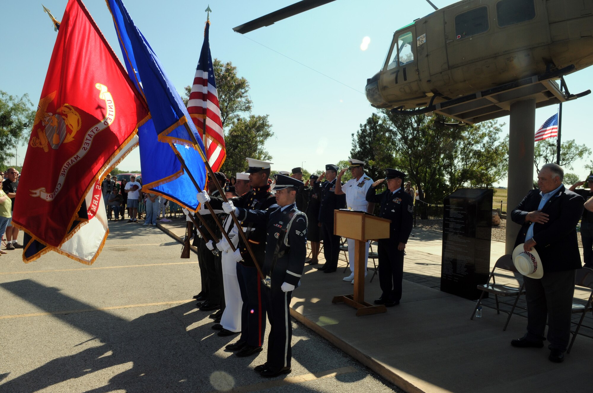 Guests and participants salute the flag at the Vietnam Veterans' Memorial at San Angelo Regional Airport Mathis Field May 25. Navy Capt. Dan Cain, a San Angelo Central High School graduate, was the guest speaker at the ceremony. (U.S. Air Force photo by Tech. Sgt. John Barton)