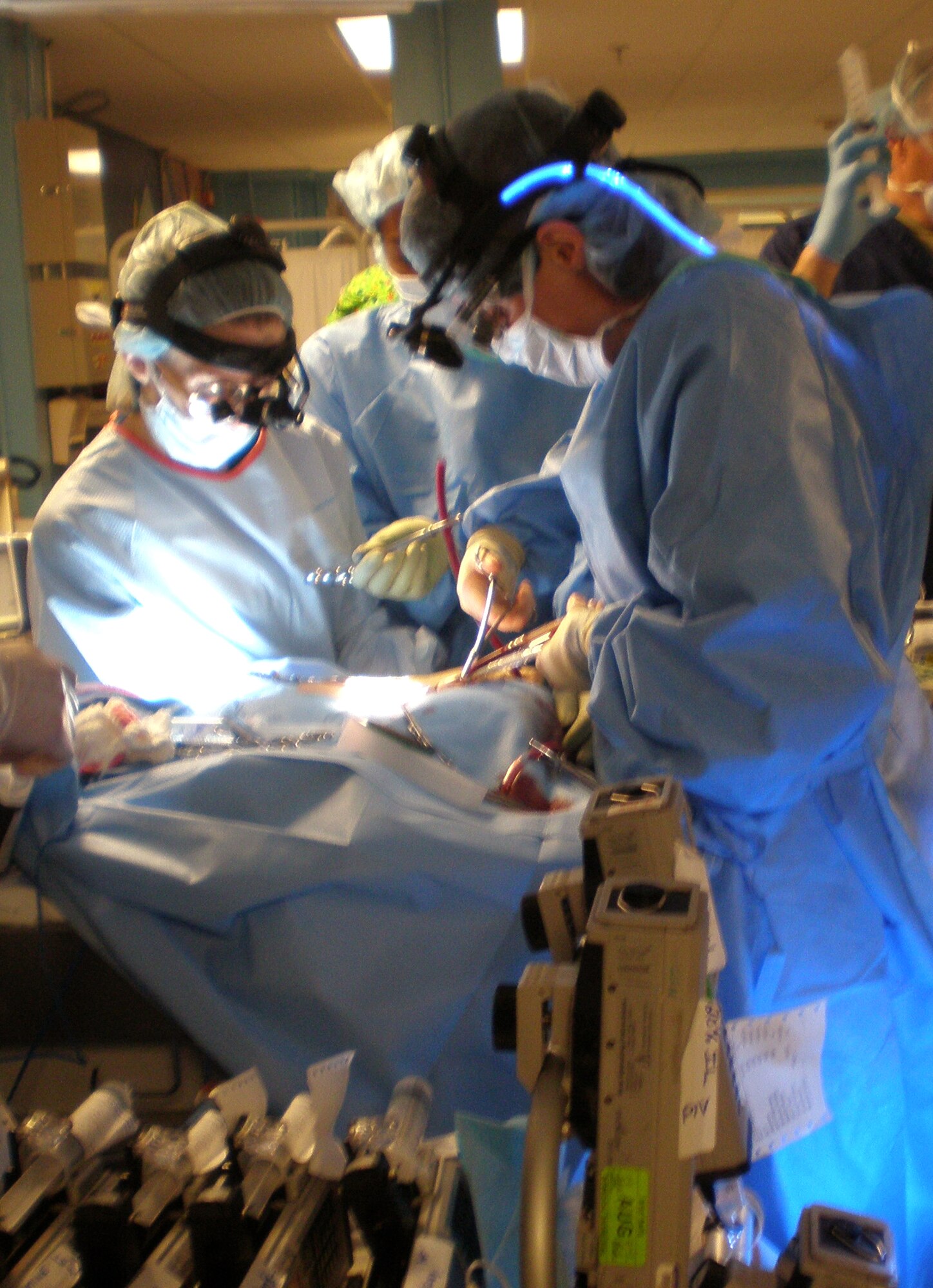 Dr. Mary Edwards (left to right) and Ford Brandon prepare a 9-month-old infant at U.S. Naval Hospital Okinawa, Japan, for a 15-hour flight to San Antonio May 25. A joint U.S. military team from several organizations helped move the infant, plus another, over the Memorial Day weekend to the continental United States for specialized care. Doctor Edwards is a Tripler Army Medical Center pediatric surgeon, and Mr. Brandon is a Wilford Hall Medical Center extracorporeal membrane oxygenation coordinator. (Courtesy photo)