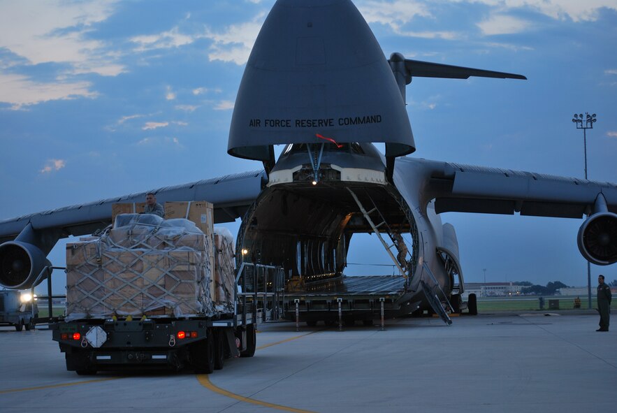 The Alamo Wing flight line is always busy, even in the hours before the sun rises. On this early morning, a C-5A was being prepped for a photography shoot for the cover of Airman Magazine. The aircraft, one of the first to receive new instrumentation through the Avionics Modernization Program, was prepared for the morning shoot by maintainers from the 433rd Airlift Wing and Airmen from the 733rd Training Squadron. Though the aircraft wasn't actually being loaded for a mission, the photos are set up to help show some of the steps taken before an actual mission. The Alamo Wing Airmen and C-5 will be featured on the cover of the July 2009 issue of Airman Magazine. (U.S. Air Force Photo/Master Sgt. Collen McGee)