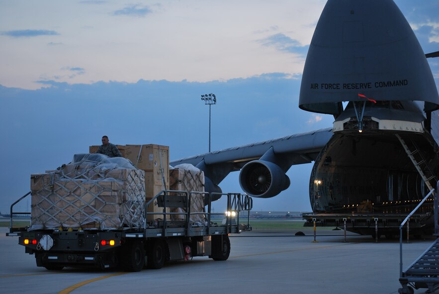 The Alamo Wing flight line is always busy, even in the hours before the sun rises. On this early morning, a C-5A was being prepped for a photography shoot for the cover of Airman Magazine. The aircraft, one of the first to receive new instrumentation through the Avionics Modernization Program, was prepared for the morning shoot by maintainers from the 433rd Airlift Wing and Airmen from the 733rd Training Squadron. Though the aircraft wasn't actually being loaded for a mission, the photos are set up to help show some of the steps taken before an actual mission. The Alamo Wing Airmen and C-5 will be featured on the cover of the July 2009 issue of Airman Magazine. (U.S. Air Force Photo/Master Sgt. Collen McGee)