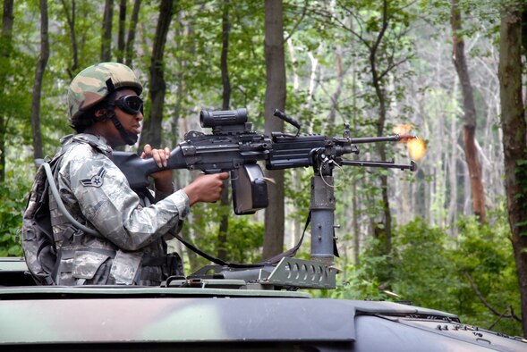 A student in the Air Force Phoenix Warrior Training Course fires a machine gun loaded with blank ammunition during a training scenario for the course in mounted patrol on May 25, 2009, on a Joint Base McGuire-Dix-Lakehurst, N.J., range.  The course, taught by the U.S. Air Force Expeditionary Center's 421st Combat Training Squadron, prepares security forces Airmen for upcoming deployments. (U.S. Air Force Photo/Staff Sgt. Paul R. Evans)