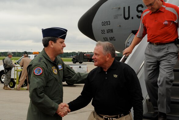 SCOTT AIR FORCE BASE, Ill. -- Lieutenant General Vern M. Findley, Air Mobility Command vice commander, greets Wake Forest University Football Coach Jim Grobe upon his arrival here. Coach Grobe, along with six other NCAA coaches visited Scott AFB at the start of the Coaches Tour 2009, sponsored by Morale Entertainment, LLC, in association with Armed Forces Entertainment. The coaches included Coach Grobe; Ohio State University Football Coach Jim Tressel (far right); 2008 Coach of the Year Mack Brown, University of Texas; Troy Calhoun, U.S. Air Force Academy; Rick Neuheisel, UCLA; Houston Nutt, University of Mississippi; and Tommy Tuberville, former Auburn University coach. Following their stop at Scott AFB, the coaches will continue overseas where they will spend several days meeting and talking to troops and coaching flag football games. (U.S. Air Force photo/Bekah Clark, Hq. AMC Public Affairs)