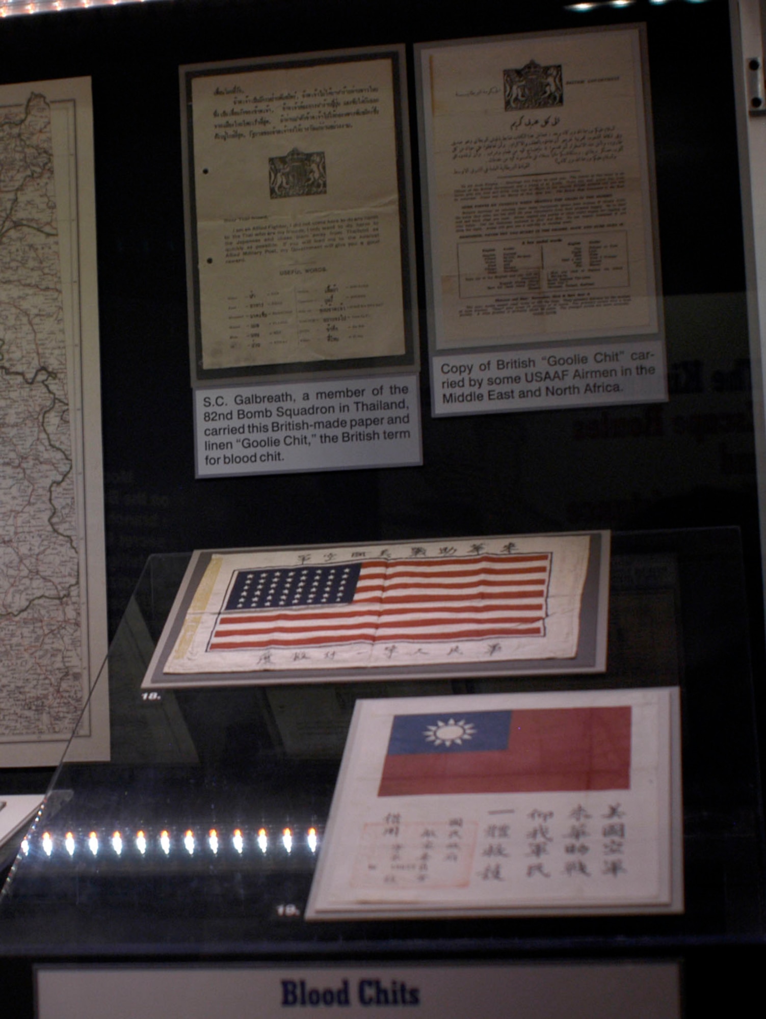 DAYTON, Ohio - This cotton-backed silk flag has Chinese characters that request help and protection. Ernest Tyndall, a P-47 pilot in the 19th Fighter Squadron, carried this rayon blood chit while flying missions from Saipan and Ie Shima in 1944-45. It states: "The American Air Force has come to China to help us in the war effort. Hope that our soldiers and civilians one and all will rescue, protect, and provide them with medical care."  S.C. Galbreath, a member of the 82nd Bomb Squadron in Thailand, carried this British-made paper and linen "Goolie chit," the British term for blood chit. Copy of British “Goolie Chit” carried by some USAAF airmen in the Middle East and North Africa. These items are on display in the "Winged Boot: Escape and Evasion in World War II" exhibit in the World War II Gallery at the National Museum of the U.S. Air Force. (U.S. Air Force photo)
