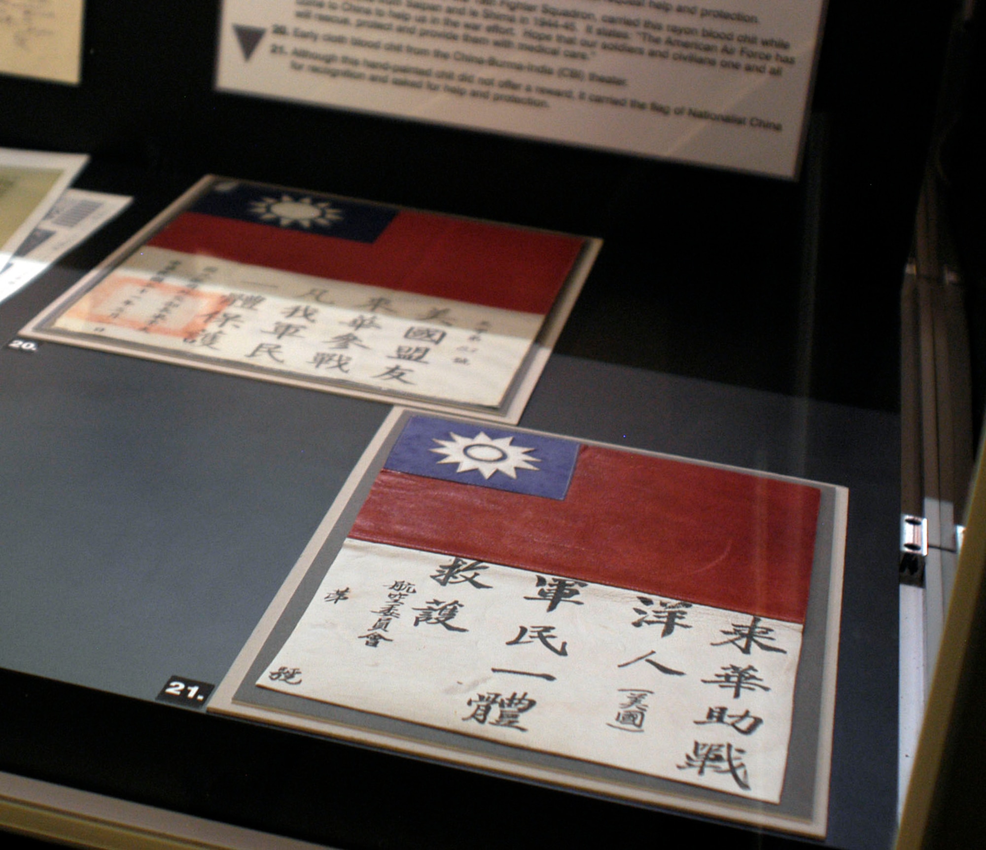 DAYTON, Ohio - Early cloth blood chit from the China-Burma-India (CBI) theater. Although this hand-painted chit did not offer a reward, it carried the flag of Nationalist China for recognition and asked for help and protection. These items are on display in the "Winged Boot: Escape and Evasion in World War II" exhibit in the World War II Gallery at the National Museum of the U.S. Air Force. (U.S. Air Force photo)