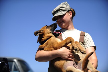 Staff Sgt. Christa Quam holds her puppy which will enter the military working dog program in a year on Lackland Air Force Base, Texas.  (U.S. Air Force photo/Senior Airman Christopher Griffin)