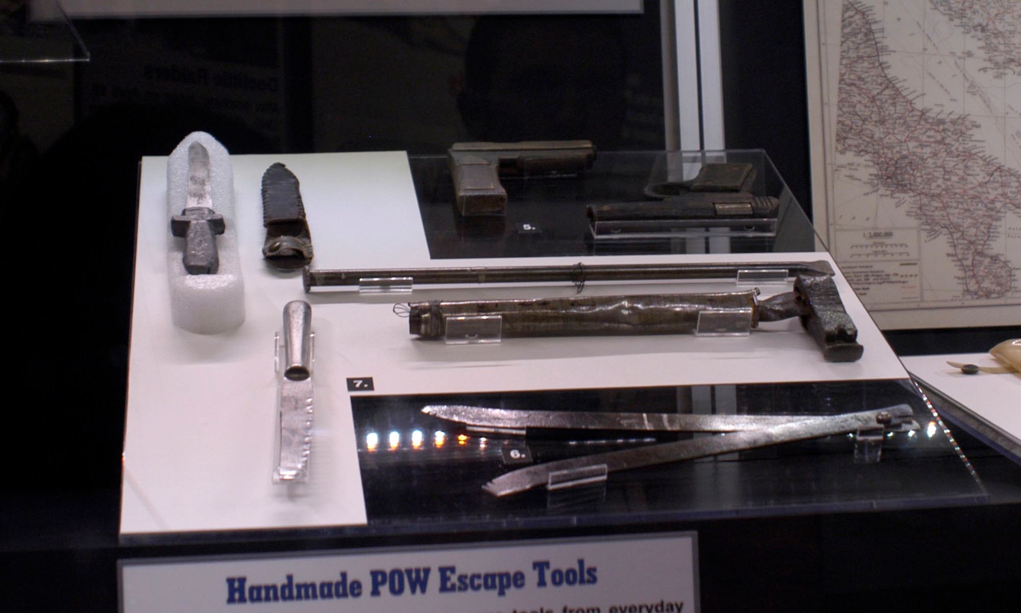 DAYTON, Ohio - Fake guns, like these fake guns made by former USAAF POWs after the war, would look very convincing during a night escape. This crude wire cutter would help an escapee to get through the barbed wire that surrounded POW camps. These POW-made implements were not only useful as escape tools, but also as potential weapons. These items are on display in the "Winged Boot: Escape and Evasion in World War II" exhibit in the World War II Gallery at the National Museum of the U.S. Air Force. (U.S. Air Force photo)