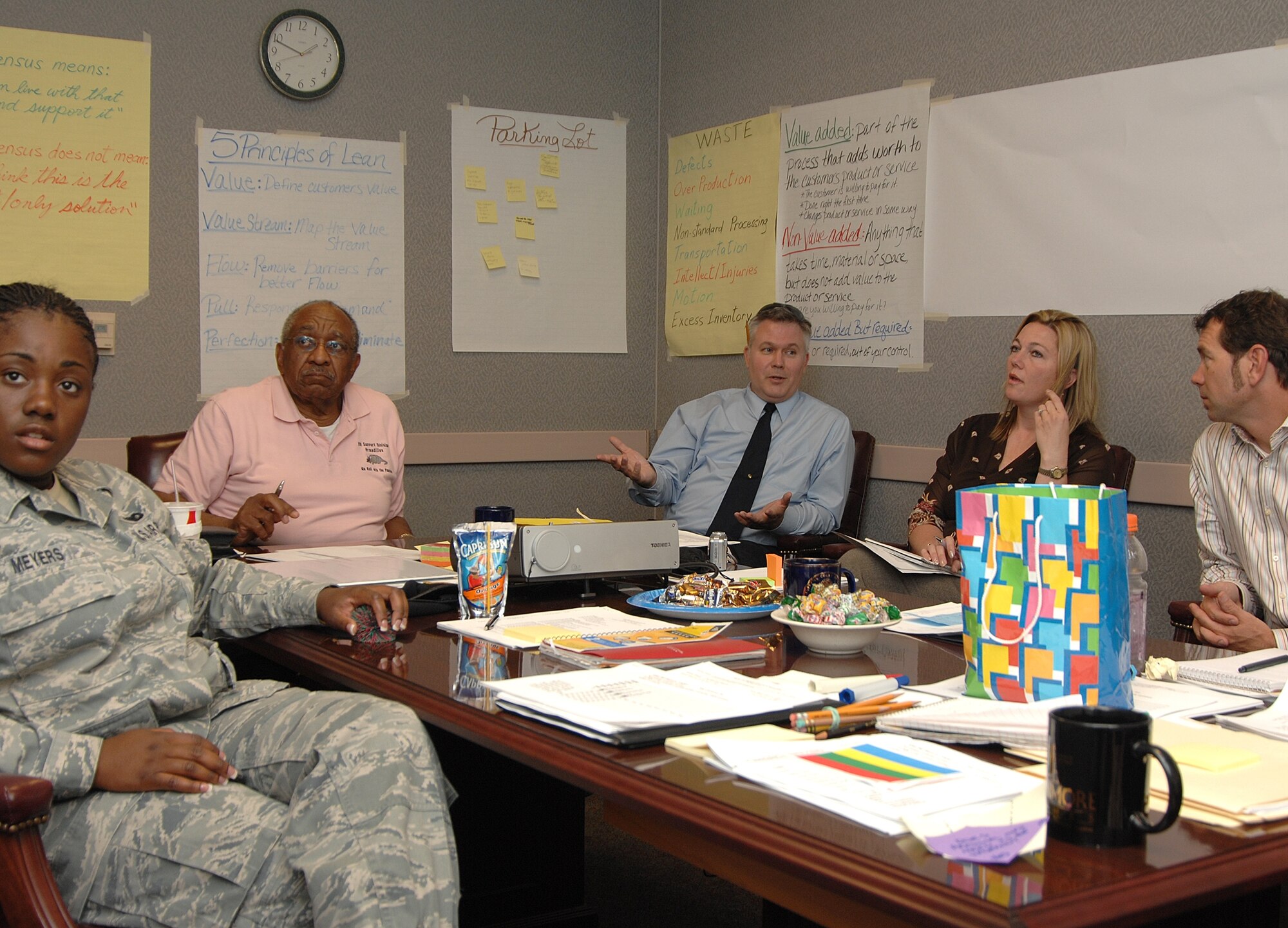 Members of the 9th Mission Support Group support division at Beale Air Force Base, Calif., along with volunteers, discuss Beale's current common access card/identification card process in order to make the process a more customer-friendly one. An Air Combat Command team assisted with the Air Force Smart Operations for the 21st Century initiative. (U.S. Air Force photo/Sean Bhakta) 