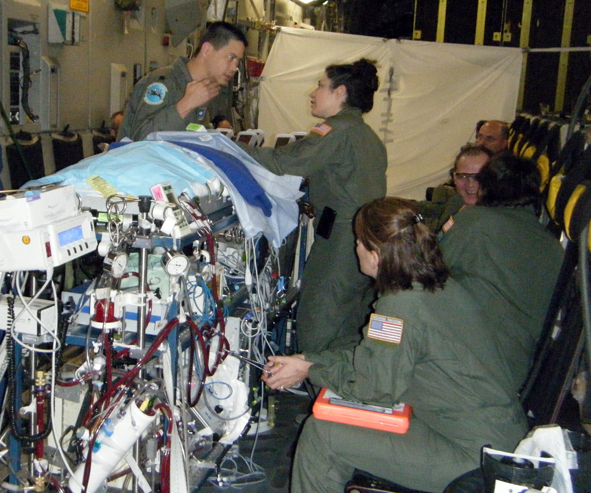 Lt. Col (Dr.) Dan Dirnberger, director neonatal intensive care, and Maj. (Dr.) Melissa Tyree, director of ECMO transport provide care to a critically ill infant during the flight from Kadena Air Base, Japan to San Antonio, Texas May 26.  The infant required more immediate and long term cardiac care than was available at the U.S. Naval Hospital in Okinawa.  Colonel Dirnberger and Major Tyree are assigned to the 59th Maternal/Child Care Squadron. (U.S. Air Force photo)