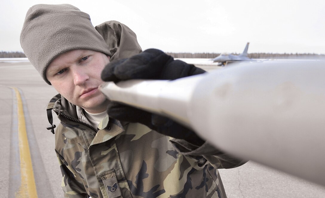 Staff Sgt. James George inspects a pitot tube on an F-16 Fighting Falcon for dents and debris April 17 during Red Flag-Alaska at Eielson Air Force Base, Alaska. Red Flag-Alaska is a Pacific Air Forces-directed field training exercise for U.S. and coalition forces who fly under simulated air-combat conditions. Sergeant George is a crew chief assigned to the Iowa Air National Guard's 132nd Fighter Wing from Des Moines.  (U.S. Air Force photo/Senior Airman Christopher Boitz) 