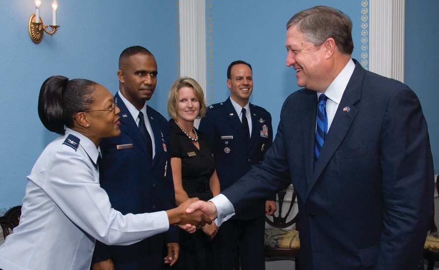 Secretary of the Air Force Michael B. Donley greets Col. Sherry L. Stearns-Boles, spouse of SECAF Leadership Award winner Maj. Sean P. Boles, during a luncheon May 22 at Maxwell's Officers' Club where Secretary Donley presented the awards to graduates of the Air War College, Air Command and Staff College, Squadron Officer School and the Senior NCO Academy. Secretary Donley spent Friday morning speaking to a combined audience of students and leaders who were attending the AWC National Security Forum. Also pictured from left are leadership award recipients Major Boles from ACSC, and Mrs. and Col. Patrick J. Owens from AWC. (U.S. Air Force photo/Melanie Rodgers Cox)