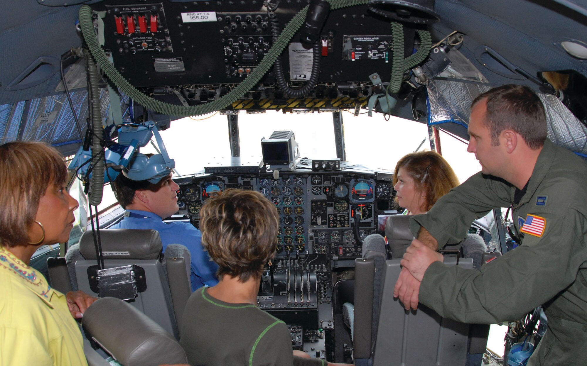 Capt. Derek Shehee, C-130 pilot with the 908th Airlift Wing, shows the flight controls to teachers from Maxwell Elementary School. The teachers took a tour of the base May 22 to become more familiar with the workplaces of many of the parents of their students. Teachers shown from left are Jo Roper, Assistant Principal Brian Perry, Diane Brewster and Becky Gorey. (U.S. Air Force photo/Jamie Pitcher)