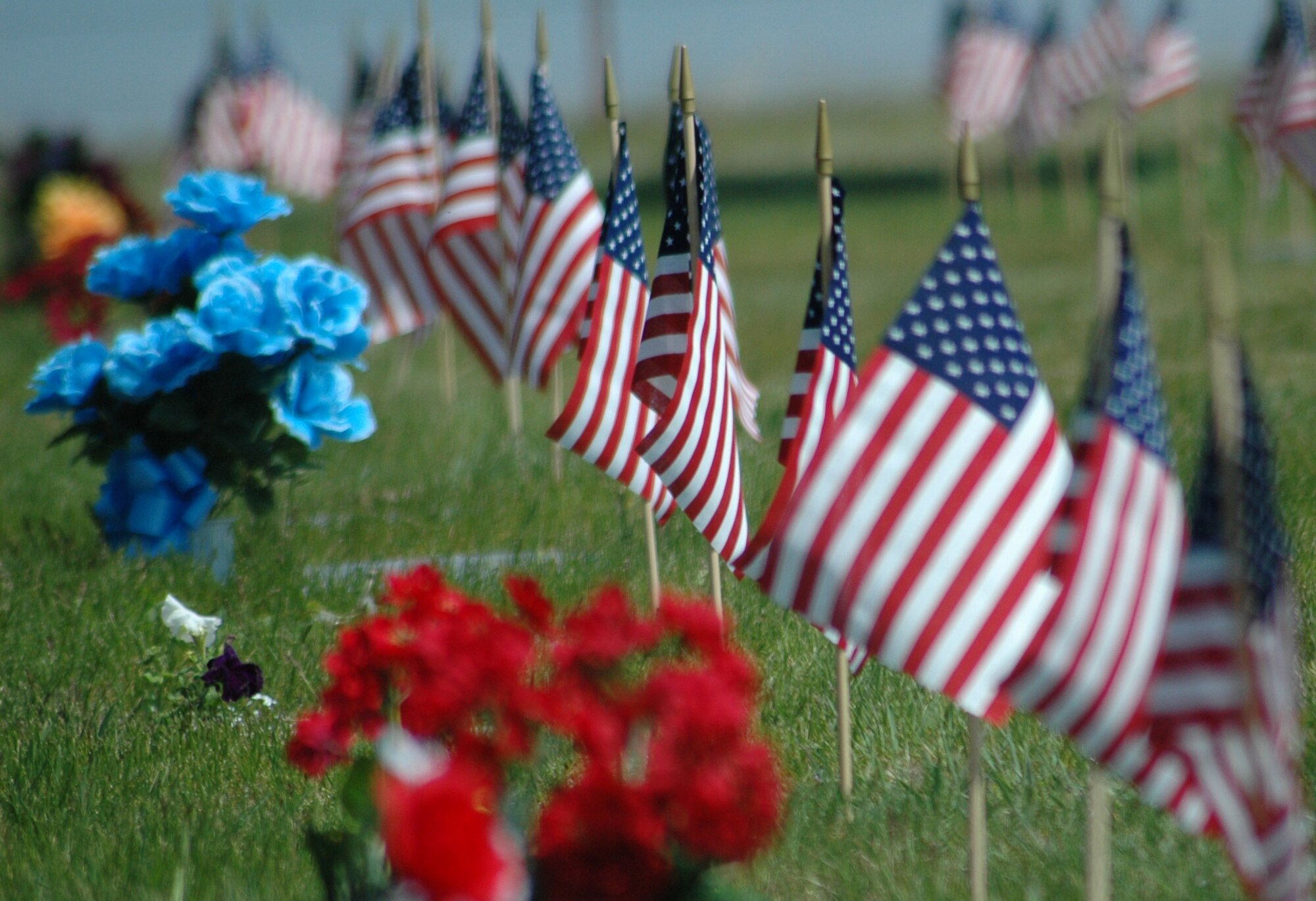 Small flags are arranged for Memorial Day near grave markers at Highland Cemetery in Great Falls. (U.S. Air Force photo/Senior Airman Dillon White)