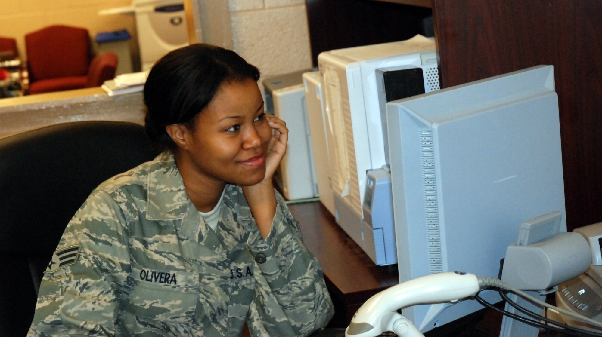 DOBBINS AIR RESERVE BASE, Ga. -- Senior Airman Jasmine Olivera, 94th Mission Support Squadron, makes an identification card for a customer May 22. Airman Olivera is a new personnelist stationed here in the customer service department. She completed three years of active-duty service at McConnell Air Force Base, Kan., before joining the Reserves. She left active duty to further pursue her educational goals and to be closer to her family. Her recommendation for new Airmen is to remain positive, stay out of trouble and show respect. (U.S. Air Force photo/Kennith Green)