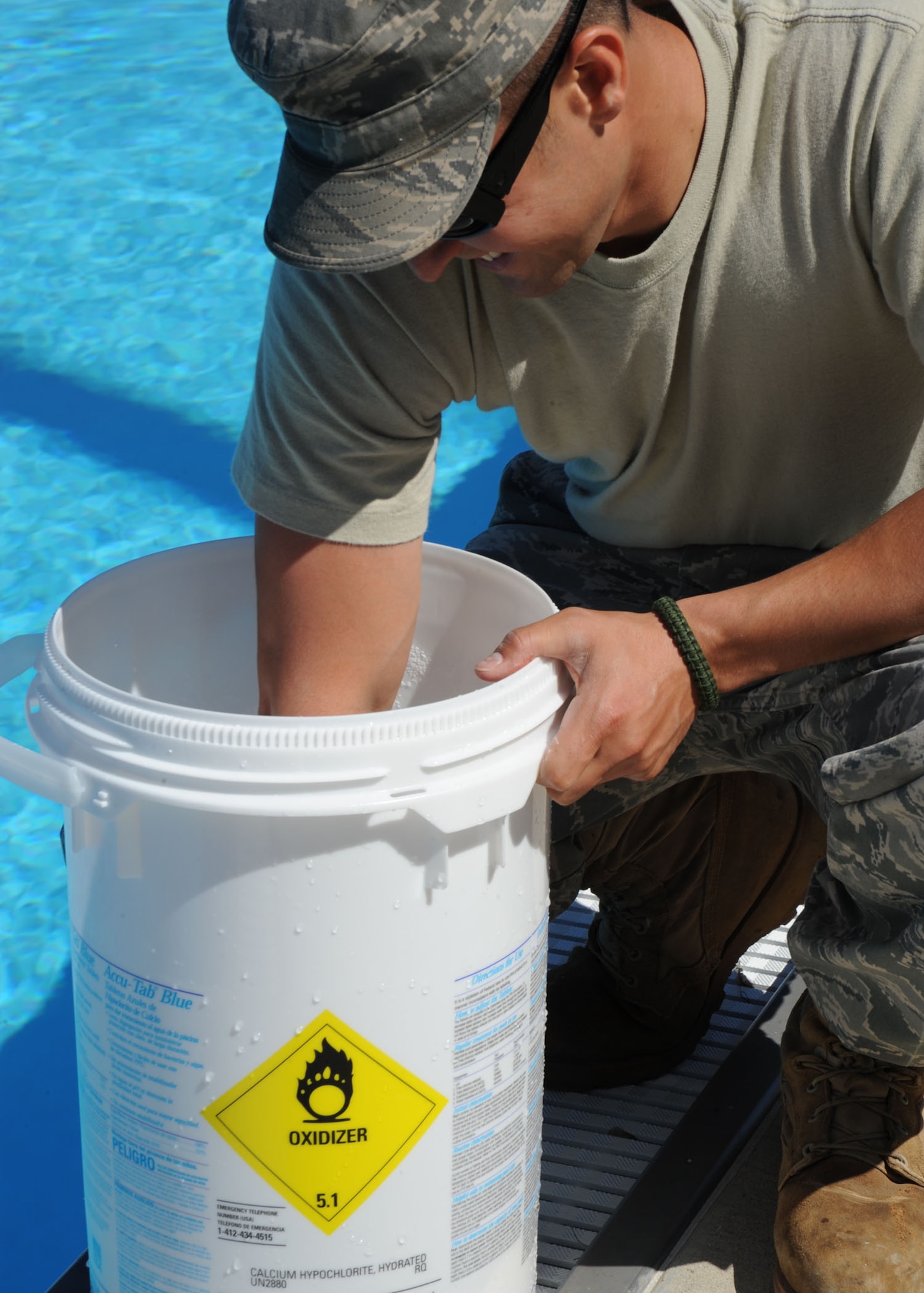 SCOTT AIR FORCE BASE, Ill. -- Staff Sgt. Ben Mayssonet,  375th Civil Engineer Squadron, mixes cyanuric acid for the Fitness Center pool at Scott May 20.  Putting cyanuric acid into the pools holds the chlorine levels, making sure they are not too high or too low. (U.S. Air Force photo/Airman 1st Class Tristin English) 