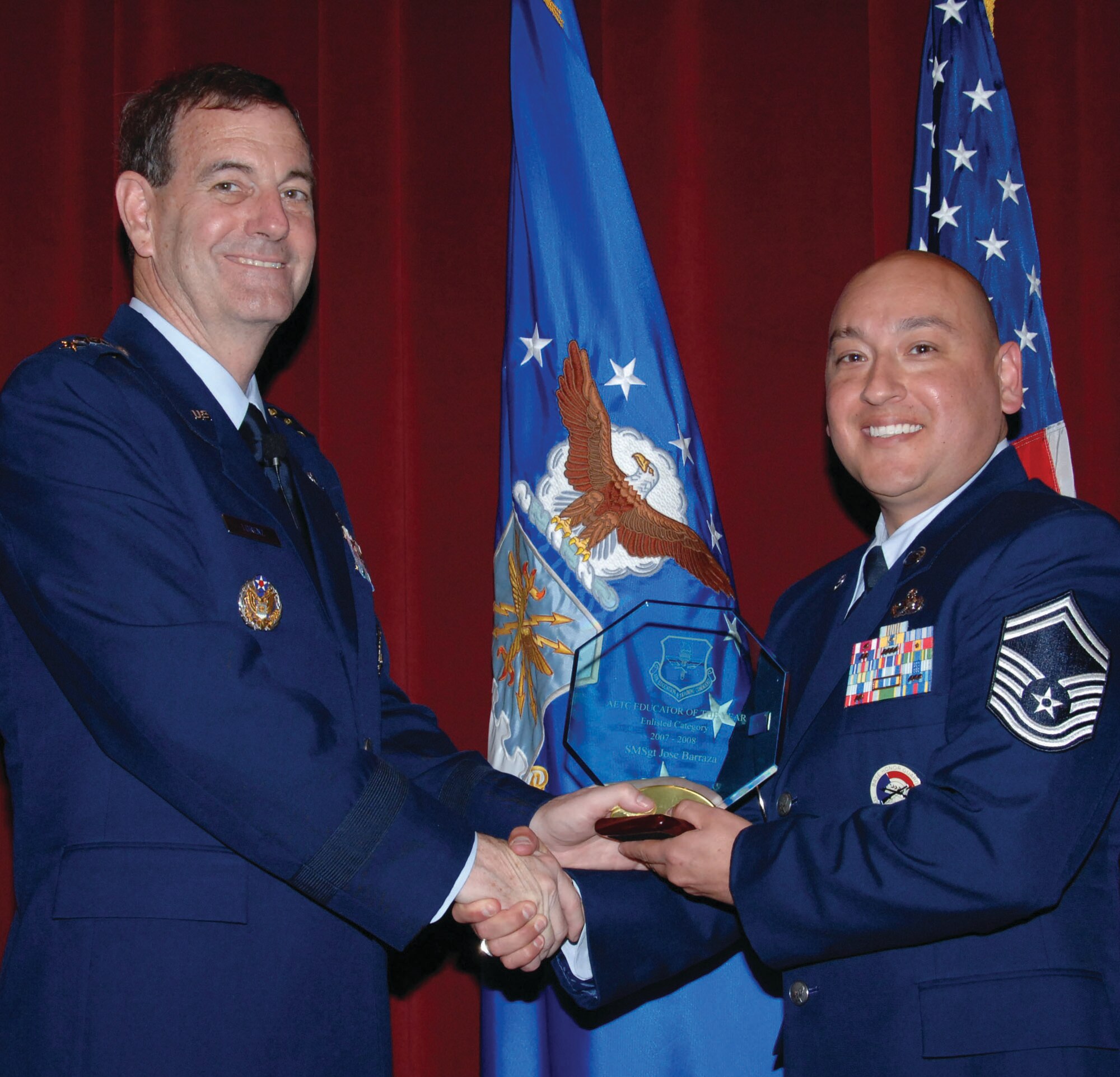 AETC Commander Gen. Stephen R. Lorenz (left) presents Gunter SNCOA Instructor Senior Master Sgt. Jose Barraza the enlisted AETC Educator of the Year Award May 22 at Air War College's Jones Auditorium. General Lorenz was at Maxwell to present awards to honor the best faculty members at Air University and writers of opinion and editorial pieces by AU faculty and students. (U.S. Air Force photo/Melanie Rodgers Cox)
