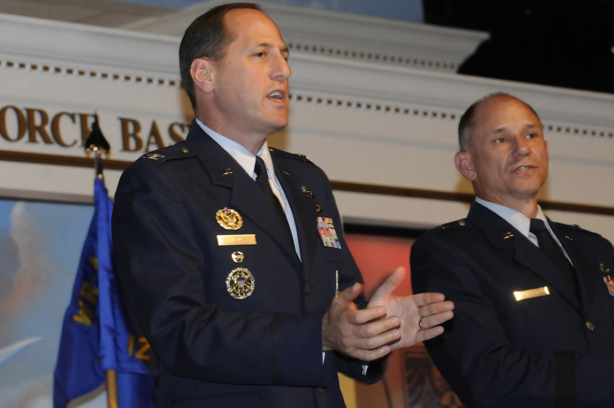 Colonel Lee K. Levy, II, new 402nd Maintenance Wing commander sings the Air Force song along with Brig. Gen. Mark A. Atkinson, former commander, at the change of command ceremony. U. S. Air Force photo by Sue Sapp