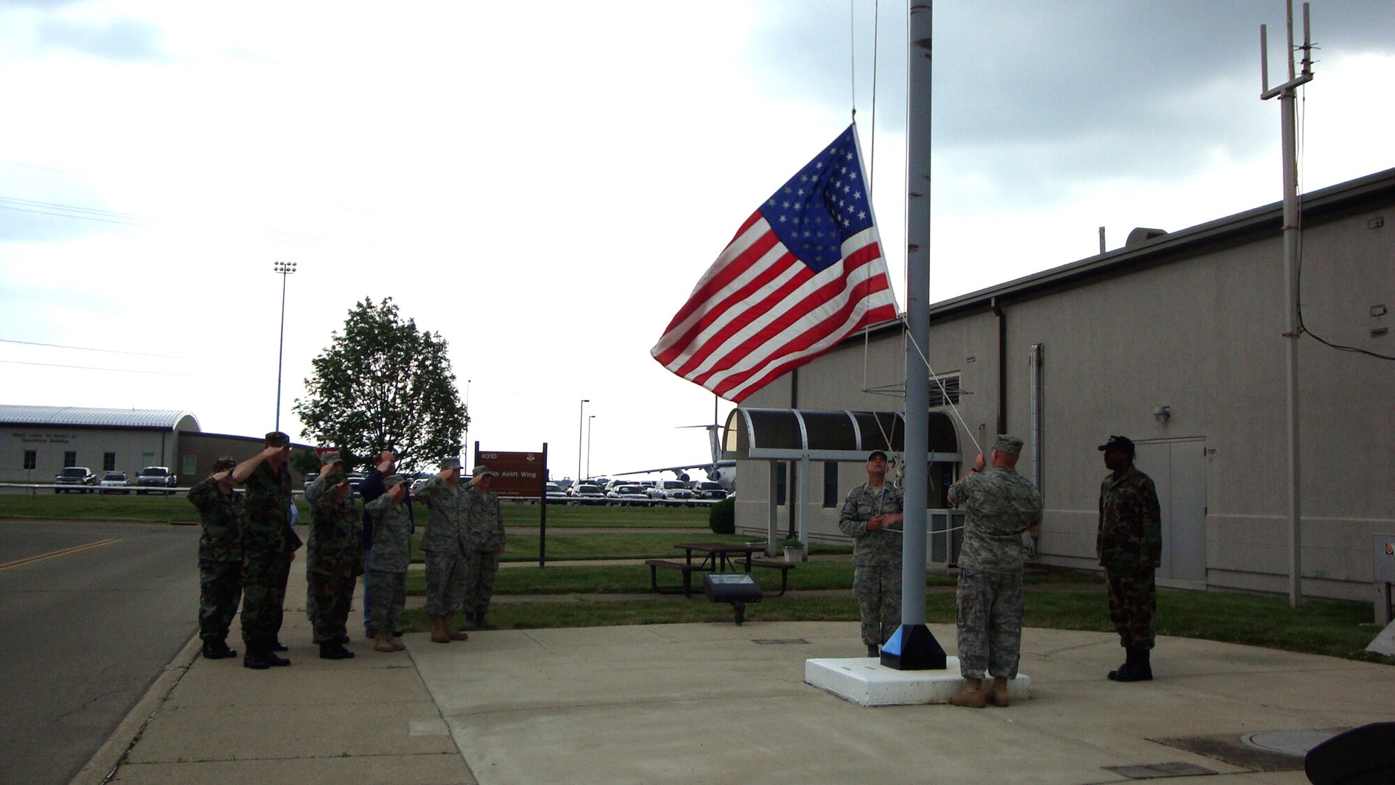 WRIGHT-PATTERSON AIR FORCE BASE, Ohio – The 445th Airlift Wing held an afternoon ceremony May 28, 2009, by lowering the American flag from half staff to honor and remember the late first Chief Master Sergeant of the Air Force Paul W. Airey. Chief Master Sgt. Aaron Mouser, Master Sgt. Henry Harlow, both from the maintenance group, and Master Sgt. Mark Lyle, honor guard program manager lower the flag as a group of wing reservists stand at attention.

Chief Master Sgt. Airey and his wife Shirley's remains were buried together at Arlington National Cemetery, Va., May 28. Chief Airey, serving 27 years, became the first Chief Master Sergeant of the Air Force April 3, 1967. Chief Master Sgt. Airey retired from active duty on Aug. 1, 1970 and died March 11 in Panama City, Fla. (Air Force photo/Laura Darden)
