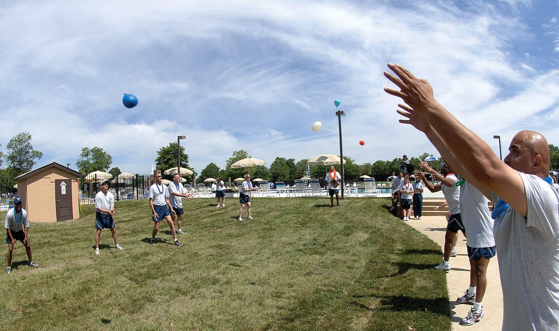Members from the 316th Wing toss water balloons in a friendly competition during the Wing Sports Day events. The purpose of the sports day is to get Airmen involved in different sporting events and build teamwork. (U.S. Air Force photo/ Senior Airman Giang Nguyen)