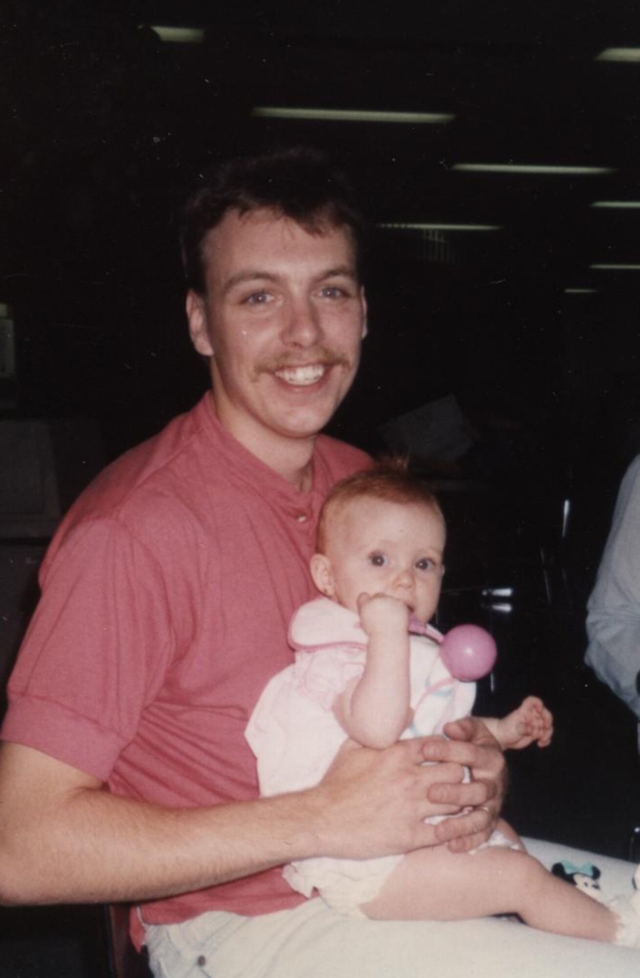 Tech. Sgt. Ralph Mount, 436th Aircraft Maintenance Squadron, holds his daughter, Hayley, when she was a baby nearly two decades ago. Using Web technology, Sergeant Mount watched his daughter graduate from Caesar Rodney High School from his deployed location in Southwest Asia May 30. (Courtesy photo)