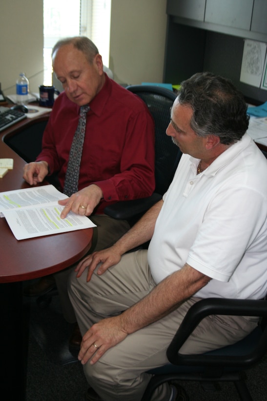 Mr. Lee Hutchinson, 911th Airlift Wing director of civilian personnel, and Mr. Ronald Piche, personnel assistant, review employment contracts. As the new director of civilian personnel, Mr. Hutchinson will manage all civilian personnel issues for the entire Wing. (Photo By Master Sgt. Mark Winklosky)