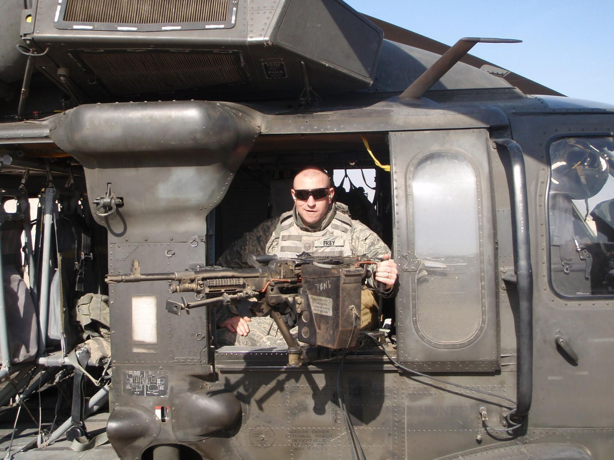 A photo shows Master Sgt. Duane Frey in a helicopter during his deployment to Iraq from September 2008 to March 2009. During some of his travels to about 16 regional contracting centers scattered across Iraq (as far north as Mosul and as far south as Bucca), Sergeant Frey’s team engaged with the enemy trying to harm the team via improvised explosive devices, small arms fire, mortars and rockets. (Courtesy photo)