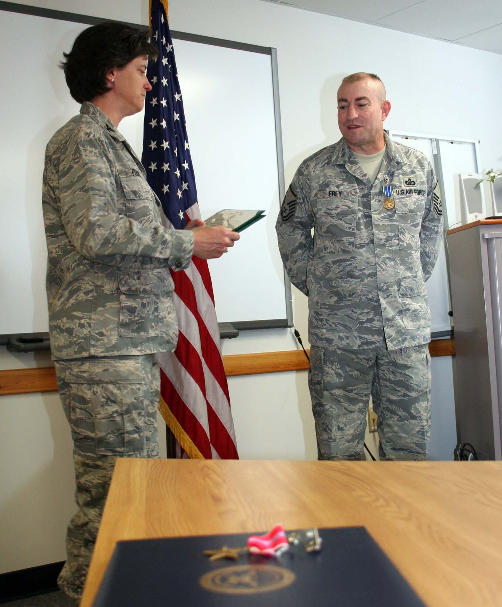 Col. Peggy Poore, 65th Air Base Wing commander, explains to friends and family members at the presentation ceremony what Master Sgt. Duane Frey, 65th Contracting Squadron, did in Iraq to earn the Army Commendation Medal. Sergeant Frey earned the medal for disarming a U.S. soldier who was drunk in a deployed location and preventing the soldier from endangering herself and others. In the same ceremony Sergeant Frey was also presented the U.S. fourth-highest combat decoration, the Bronze Star, which he earned for his actions in support of Operation Iraqi Freedom in 2008.  (U.S. Air Force photos by Staff Sgt. Olufemi Owolabi) 