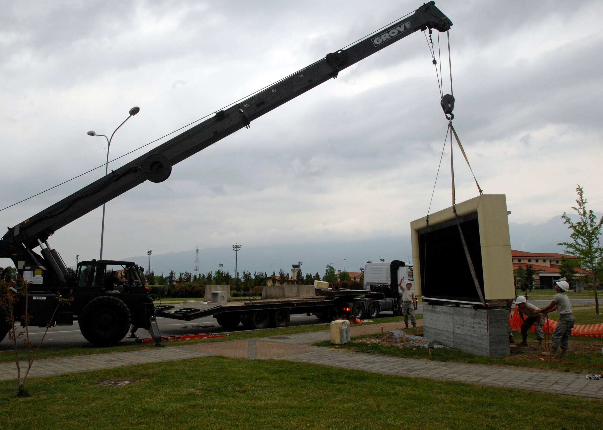 Airmen from several 31st Civil Engineer Squadron sections teamed up to disconnect, transport, secure, power back up a gigantic marquee sign May 15, 2009, from the intersection near the base commissary over to the newly opened South Gate on Area F of Aviano Air Base, Italy.  The marquee is used to highlight open to the public events, programs and award winners.  (U.S. Air Force photo/ Staff Sgt. Mercedes Crossland)
