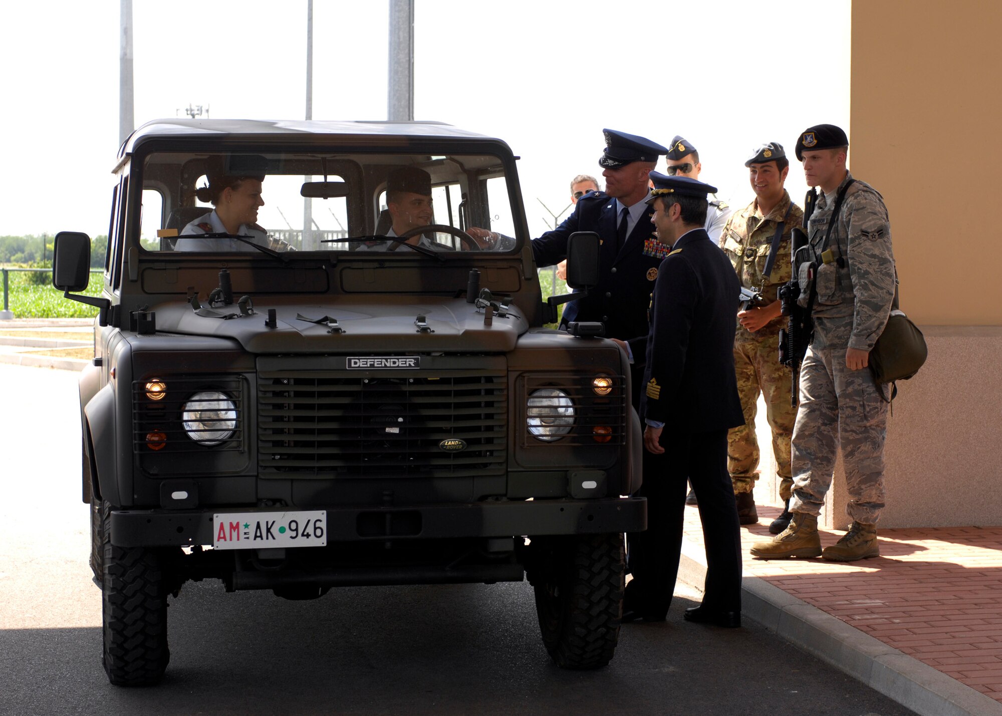 Brig. Gen. Craig Franklin, 31st Fighter Wing commander and Col. Filippo Zampella, the Italian Air Force "Pagliano e Gori" Airport commander, welcome Aviere Capo Marco Vellucci and Valeria Cerocchi of the ITAF following the South Gate ribbon cutting ceremony at Aviano Air Base, Italy, May 26, 2009.  The ITAF members are the first to officially enter through the new 24-hour gate located near the Area F softball fields and outdoor recreation. (U.S. Air Force photo/ Staff Sgt. Mercedes Crossland)