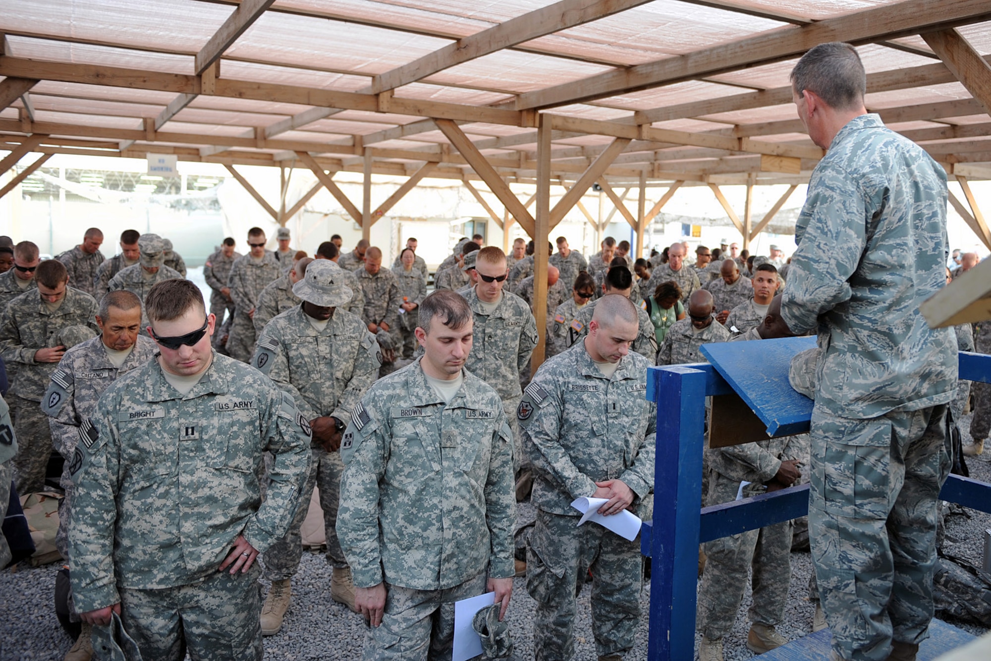 SOUTHWEST ASIA -- Air Force Chaplain (Capt.) Larry Fowler, 586th Air Expeditionary Group, leads a prayer before a group of service members depart from the Navy Customs Facility for their Rest and Relaxation Leave from a base in the Middle East, May 27. Chaplain Fowler took the time to greet with the service members before they departed for the long trip home and reminded them to take the time to relax and enjoy it with their families. (U.S. Navy photo by Navy Petty Officer 2nd Class Jorge Saucedo)