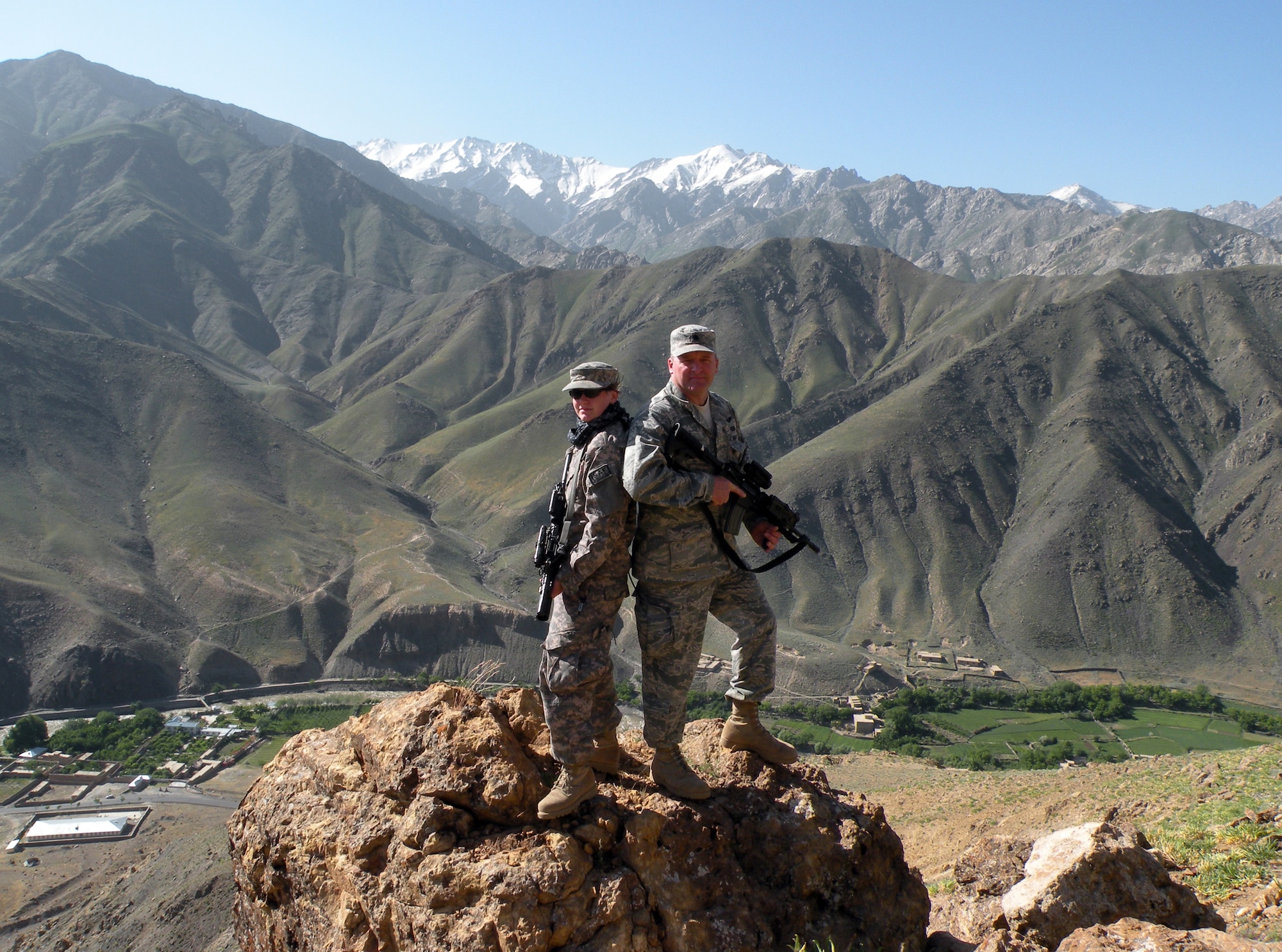 Senior Airman Ashton Goodman and Lt. Col. Mark E. Stratton atop "Lion Hill" behind their Forward Operating Base in Afghanistan May 24, 2009. Colonel Stratton served as the Panjshir Provincial Reconstruction Team's commander while Airman Goodman spent the majority of her deployment as the Panjshir PRT's primary tactical driver and usually served as the commander's driver. Both Airmen lost their lives May 26 from wounds sustained from an improvised explosive device.  (U.S. Air Force photo by Capt. Stacie N. Shafran)
                         