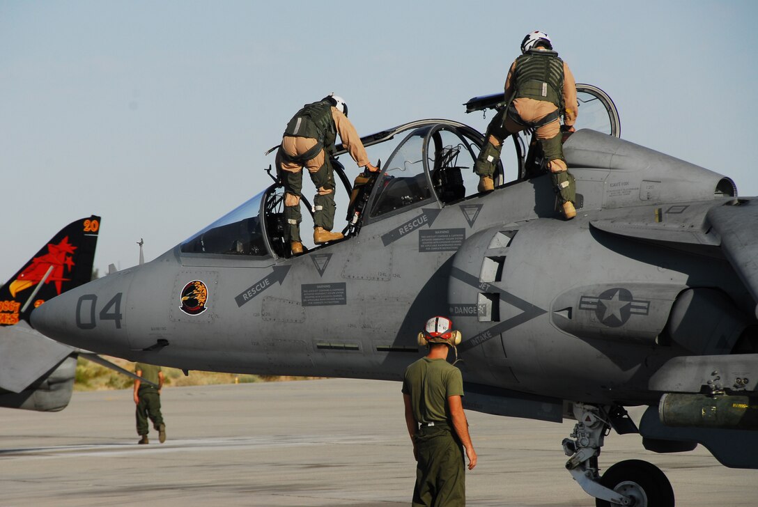 Capt. Chris Nicholson, left, Marine Attack Training Squadron 203 student pilot, and Capt. Joey Widmayer, VMAT-203 instructor, climb into an TAV-8B Harrier parked on the flight line at the Marine Corps Air Station in Yuma, Ariz., before their flight May 29, 2009. VMAT-203 has the only two-seated Harriers in the Corps, used for training purposes.