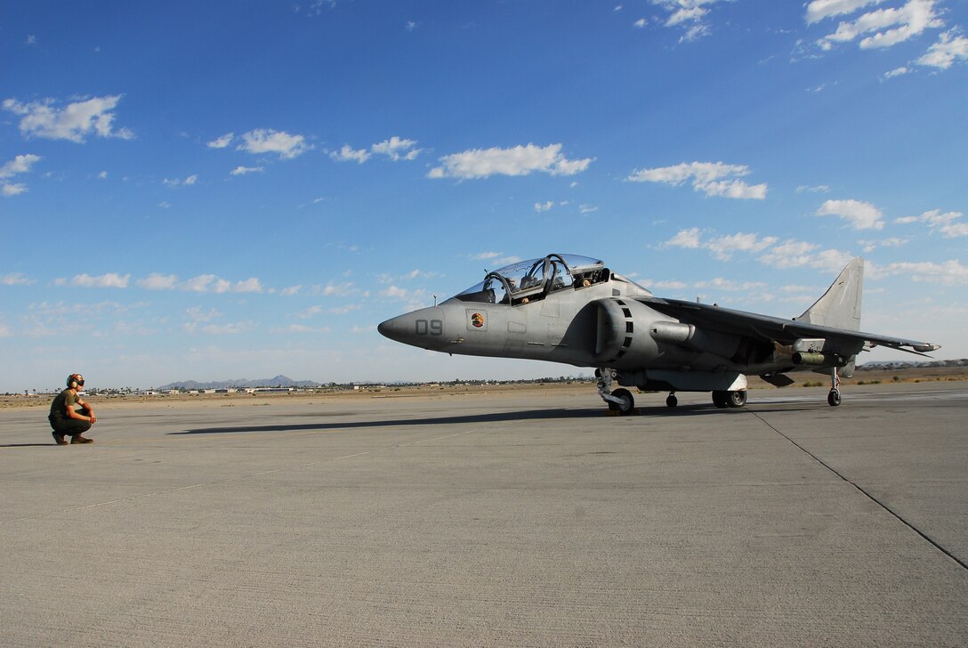 Lance Cpl. Justin Cooper, Marine Attack Training Squadron 203 plane captain, waits to direct a pilot in a TAV-8B Harrier before its flight from the Marine Corps Air Station in Yuma, Ariz., May 29, 2009. VMAT-203 has the only two-seated Harriers in the Corps, used for training purposes.