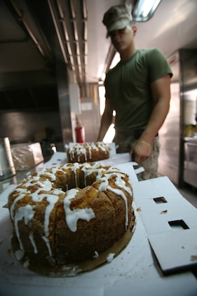 Lance Cpl. John Worman, a field food service specialist with Combat Logistics Battalion 4, 2nd Marine Logistics Group (Forward), prepares a dessert item at Contingency Outpost Viking, Iraq, May 30, 2009. The six Marines from CLB-4 are able to cook one to three hot meals a day for the Marines and sailors aboard COP Viking. (U.S. Marine Corps photograph by Cpl. Robert S. Morgan)