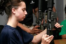 Sara Voss practices locking the M-16A2 bolt to the rear during a weapons class at a female pool function March 30 at the U.S. Marine Corps Reserve Center in Madison, Wis. Recruiting Station Milwaukee recruiters hope a new focus on female-only functions will lower its female pool attrition rate, which is currently at 26 percent. Voss is a poolee at Recruiting Substation Green Bay, Wis.