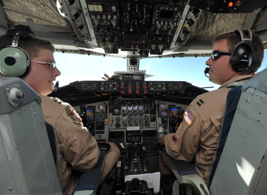 Capt. Eric Junkins (on right) and Capt. Chris Dieter fly a KC-135 Stratotanker carrying NCAA football coaches to U.S. servicemembers stationed overseas. Captain Junkins is a Reserve pilot assigned to the 931st Air Refueling Group and the only aircrew member from McConnell Air Force Base, Kan., to support Coaches Tours 2008 and 2009. Captain Deiter is an active-duty pilot assigned to the 22nd Air Refueling Wing at McConnell. (U.S. Air Force photo/Tech. Sgt. Jason Schaap)