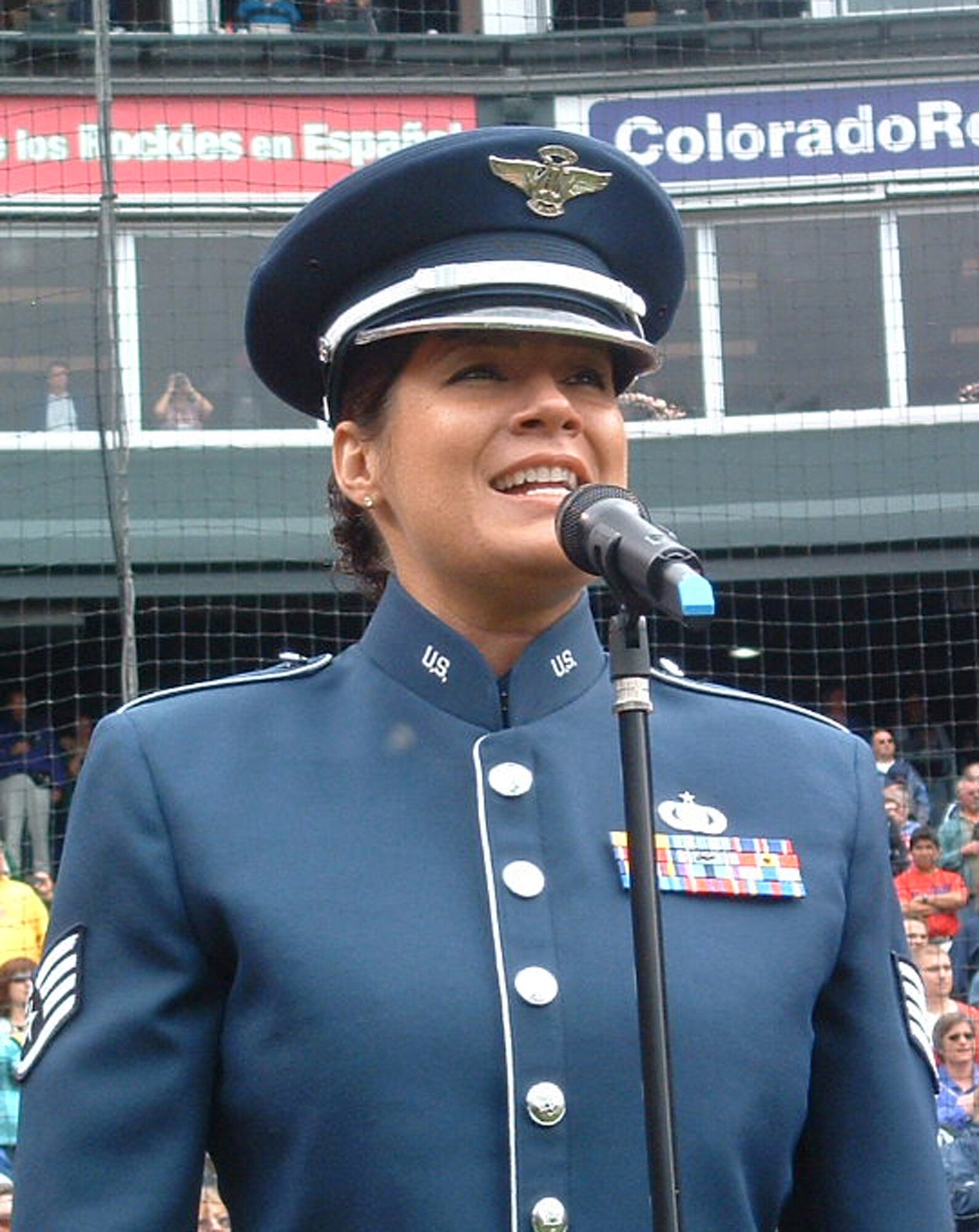Staff Sgt. Frances Kness, a vocalist with the Air Force Reserve Command Band, sings the National Anthem May 25 at Coors Field in Denver. Sergeant Kness sang in front of more than 37,000 fans, and later sang God Bless America to a roaring crowd in remembrance of Memorial Day. Sergeant Kness was joined by Senior Airman Miguel Negron, a member of the AF Reserve's 302nd Security Forces Squadron based at Peterson Air Force Base, Colo. Airman Negron threw out the first pitch for the game. Coors Field is home to the Major League Baseball's Colorado Rockies. (U.S. Air Force photo/Maj. Kallece Quinn)  