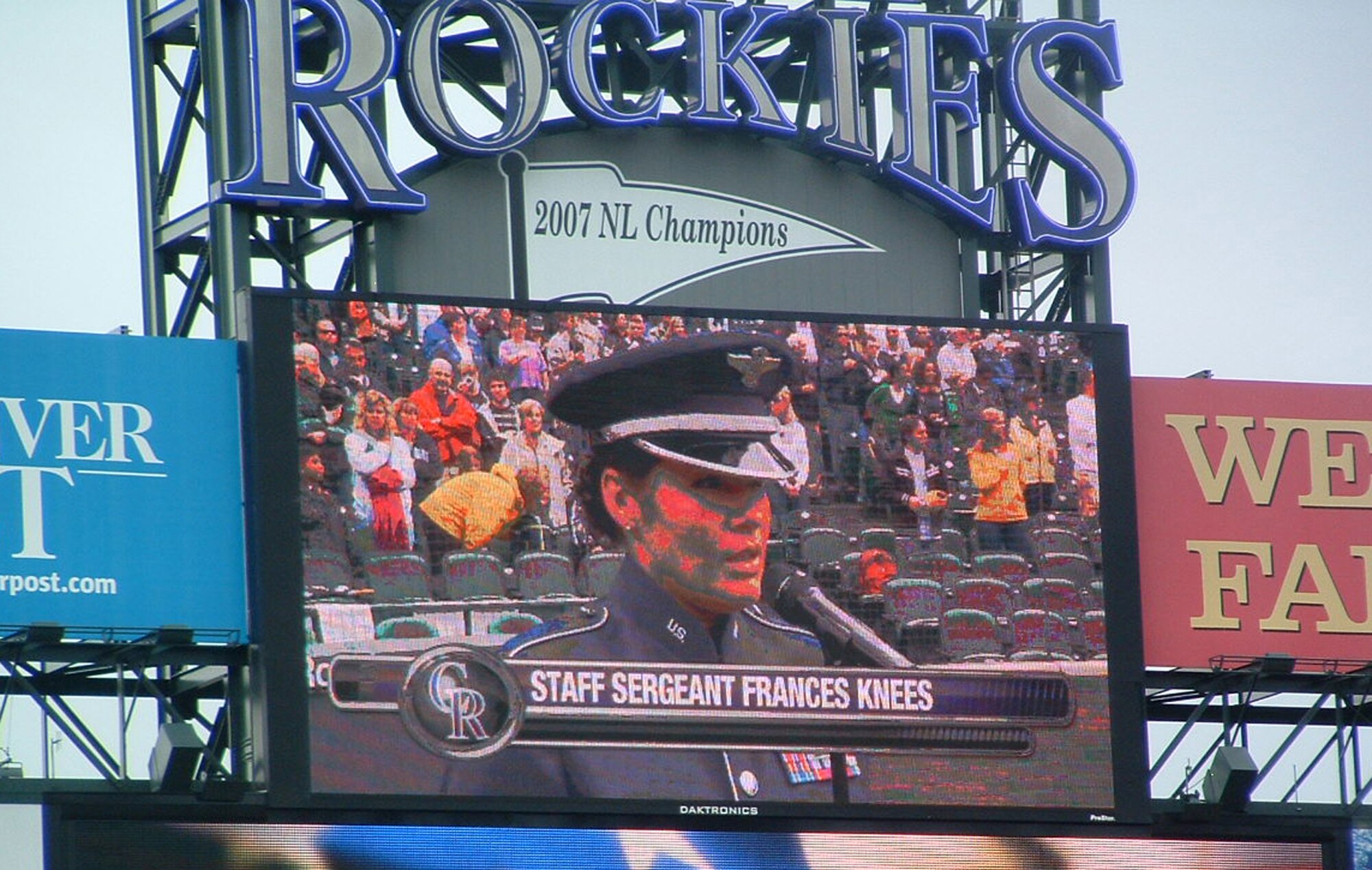 Staff Sgt. Frances Kness, a vocalist with the Air Force Reserve Command Band, is shown on the Coors Field 'jumbotron' as she sings the National Anthem May 25 in Denver. Sergeant Kness sang in front of more than 37,000 fans, and later sang God Bless America to a roaring crowd in remembrance of Memorial Day. Sergeant Kness was joined by Senior Airman Miguel Negron, a member of the AF Reserve's 302nd Security Forces Squadron based at Peterson Air Force Base, Colo. Airman Negron threw out the first pitch for the game. Coors Field is home to the Major League Baseball's Colorado Rockies. (U.S. Air Force photo/Maj. Kallece Quinn)  