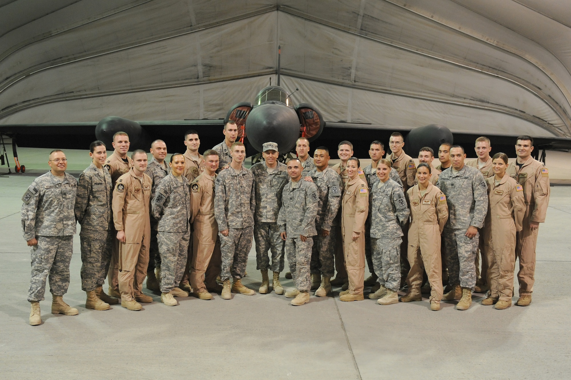 SOUTHWEST ASIA - Gen. David Petraeus, the U.S. Central Command, commander, takes a photo with the newest Airmen and Soldiers of the 380th Air Expeditionary Wing after pinning Captain bars on each of them during a promotion ceremony, May 26 at an undisclosed location in Southwest Asia. General Petraeus promoted 28 Airmen and Soldiers to the rank of Captain. (U.S. Air Force photo by Senior Airman Brian J. Ellis) (Released)