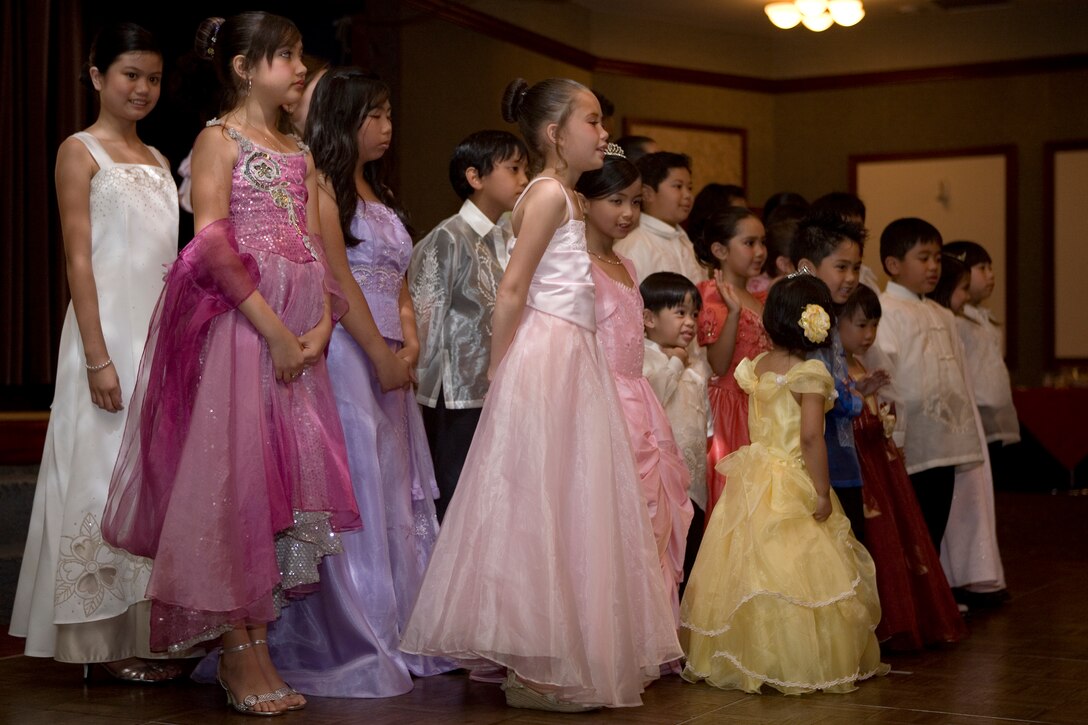 The belles and their escorts come together after the performance of the Santa Cruzan Parade during the 14th annual Pista sa Nayon festival at the Club Iwakuni ballroom here May 30. Traditionally during the Santa Cruzan, the town belles, selected for their beauty and virtuosity, are paraded through the town center over the course of several days.