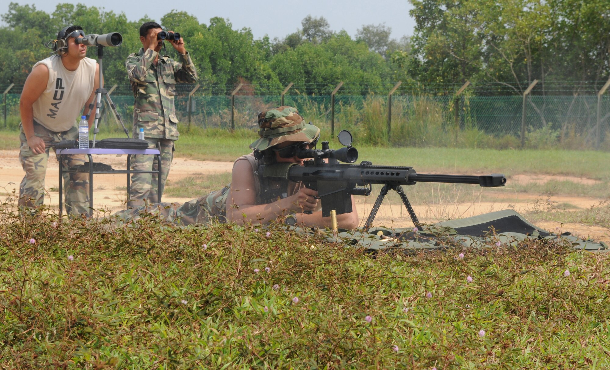 ON A MILTARY INSTALLATION IN MALAYSIA -- A pararescueman from the 320th Special Tactics Squadron fires a M107 .50 caliber sniper rifle during a tactical long range shooting course here May 29 as part of Teak Mint 09-1. Weapons specialists from the 320th STS taught members of 320th and Paskau, the special operations branch of the Royal Malaysian Air Force, during the two-day course. Teak Mint 09-1 is a training exchange designed to enhance U.S and Malaysian military training and capabilities. (Photo by Tech. Sgt. Aaron Cram)