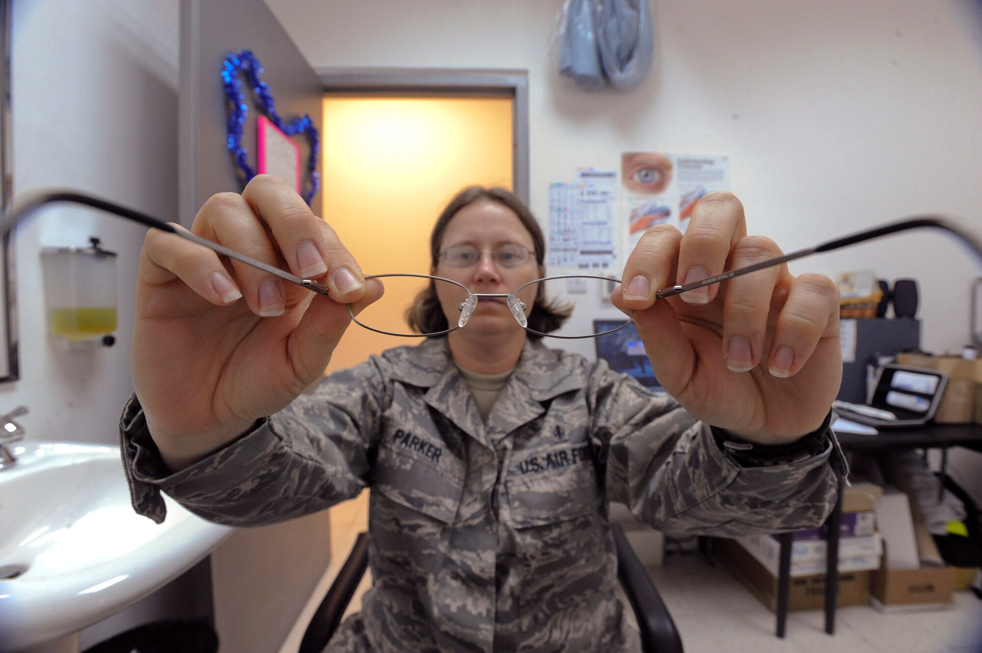 Staff Sgt. Cherie Parker, an ophthalmic technician with the 379th Expeditionary Medical Group, fits spectacle frames on a patient, May 28, 2009, in an undisclosed location in Southwest Asia. In addition to frame fitting, Sergeant Parker can perform some frame repairs on damaged glasses. Sergeant Parker hails from Washington, Ind. and is deployed from Wright-Patterson Air Force Base, Ohio in support of Operations Iraqi and Enduring Freedom and Combined Joint Task Force - Horn of Africa.  (U.S. Air Force Photo by Staff Sgt. Joshua Garcia/released)